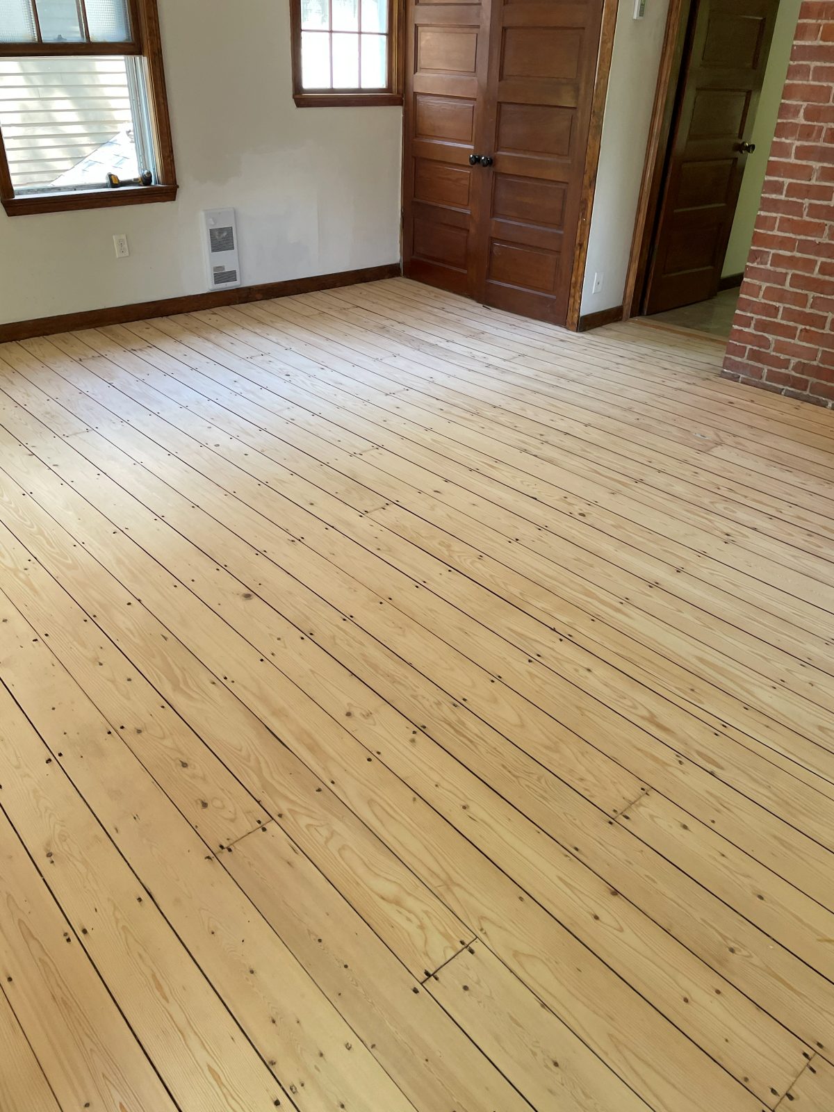 Freshly sanded hardwood floor, prepped for finishing